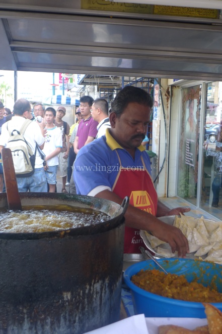 Frying them samosas...